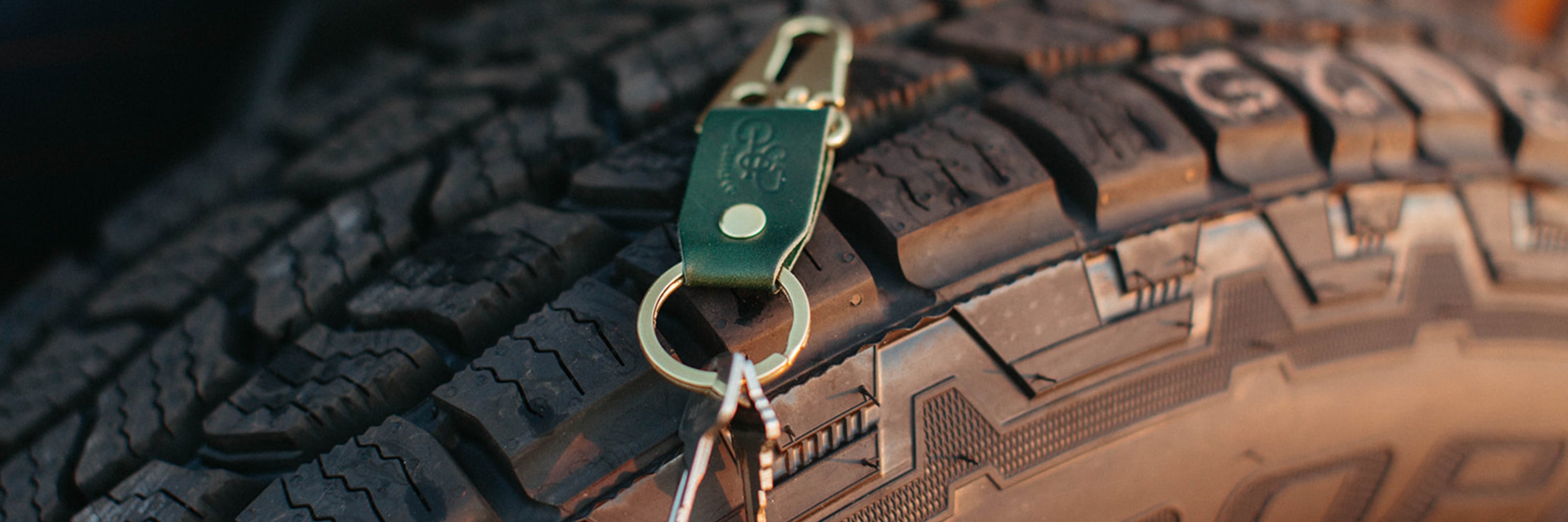 Stubby keychain in full grain leather hangs on butt pocket of a pair of levi's denim jeans