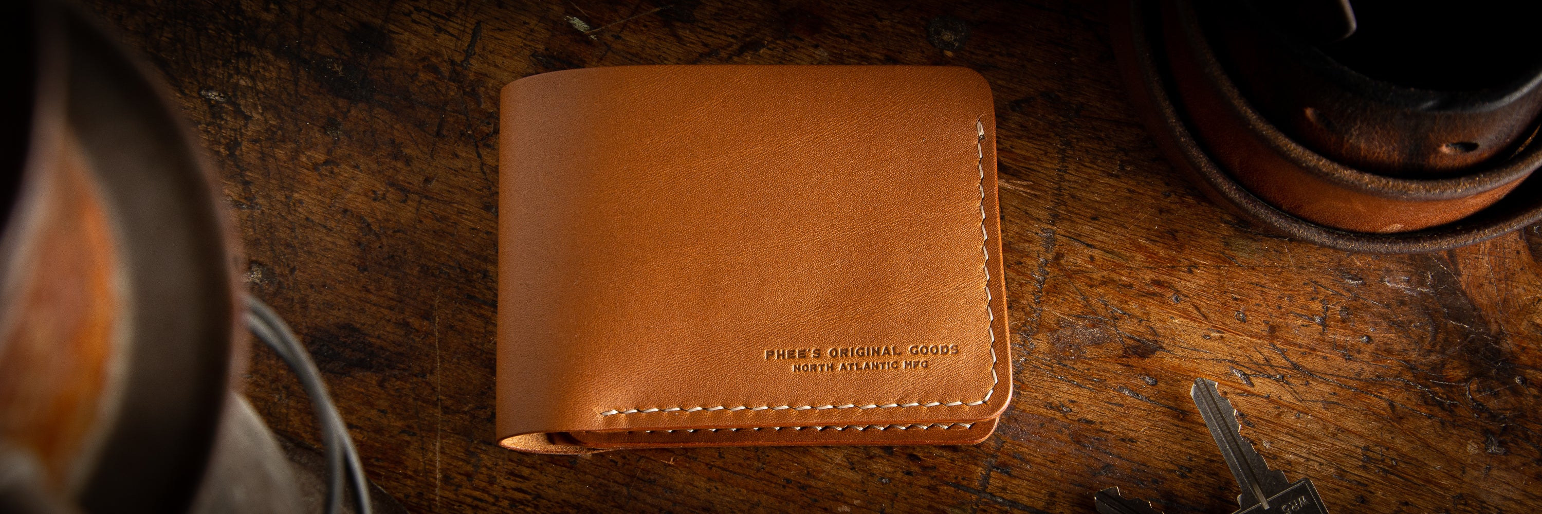 Classic Bucklaw bifold wallet in ass back pocket of a pair of levi's denim pants with a full grain leather belt