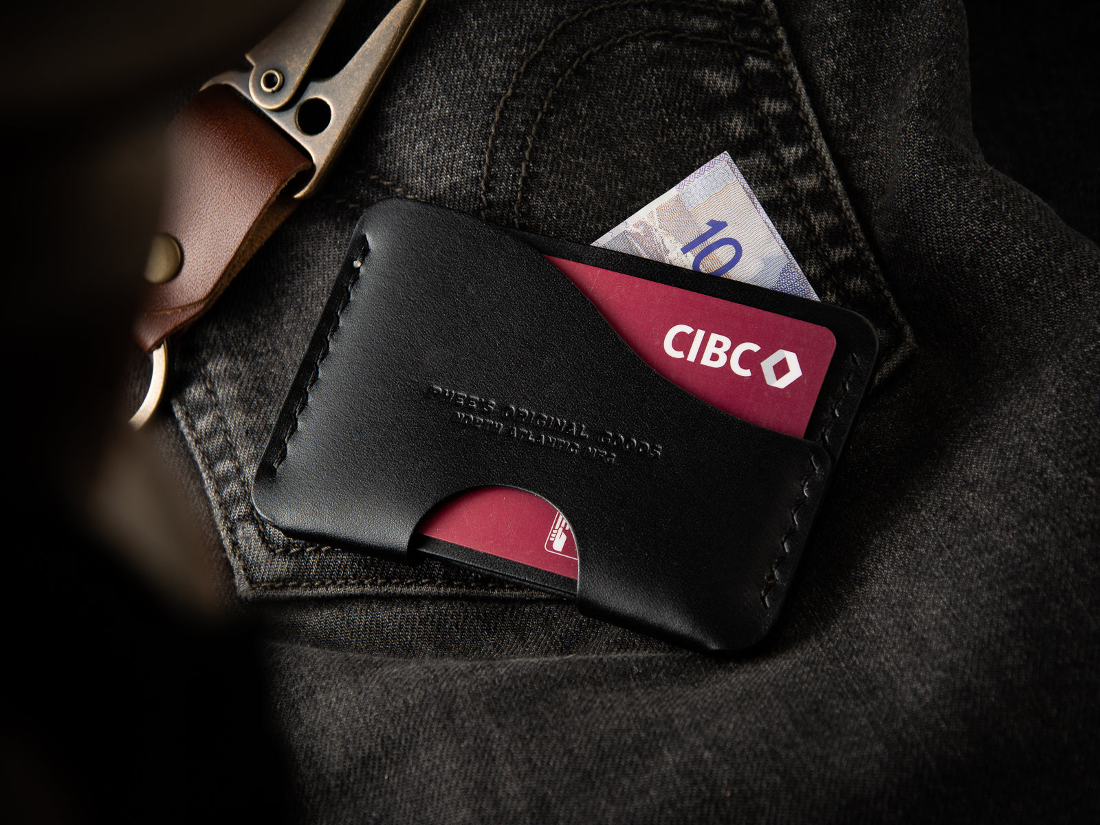 Aberdeen Leather Card Wallet - Black leather - Laying on a pair of Levi's denims