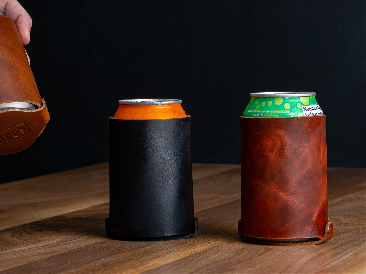 Three leather can coozies in black, brown and tan