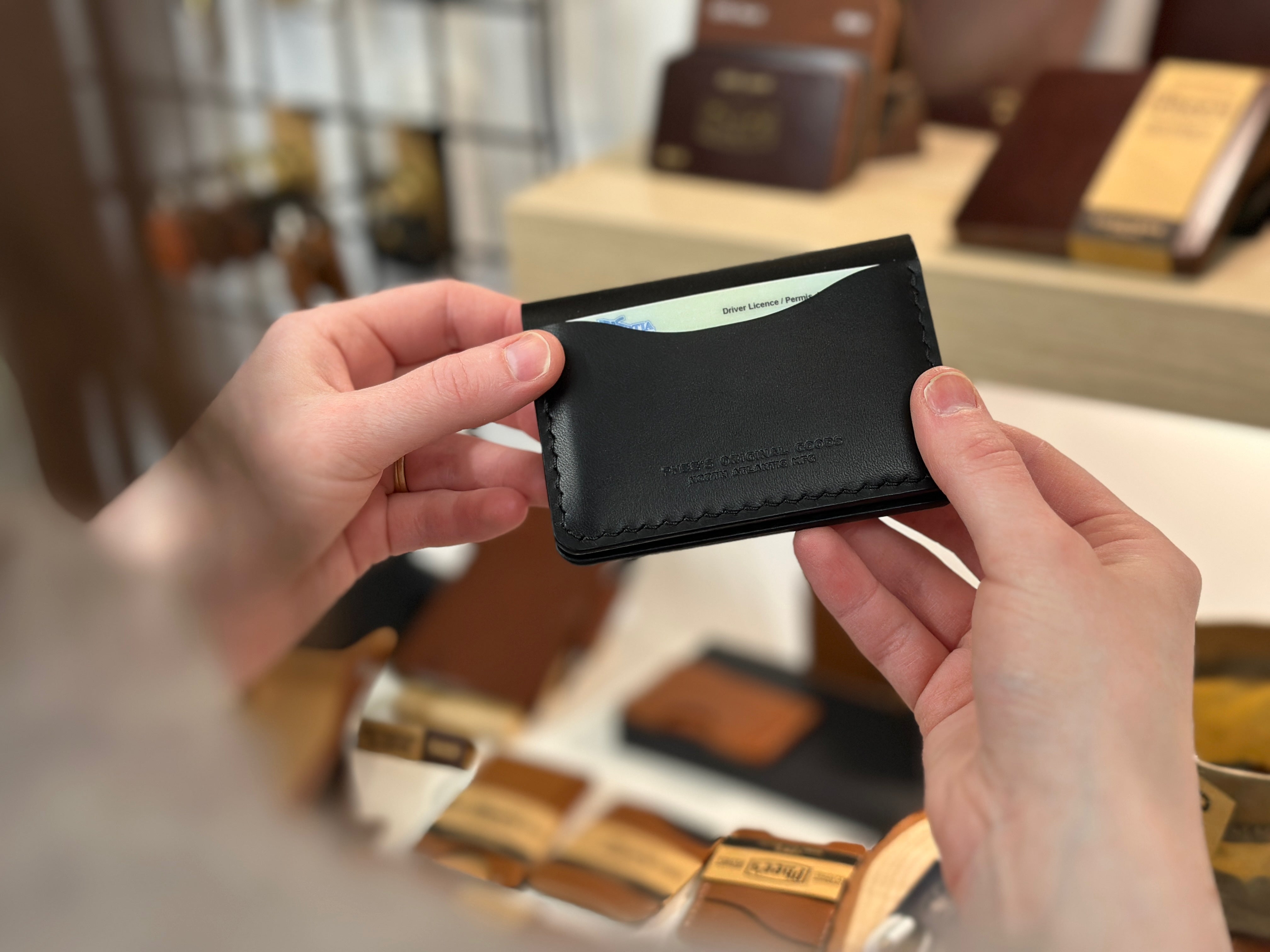 Belfry wallet with black leather, held in hands