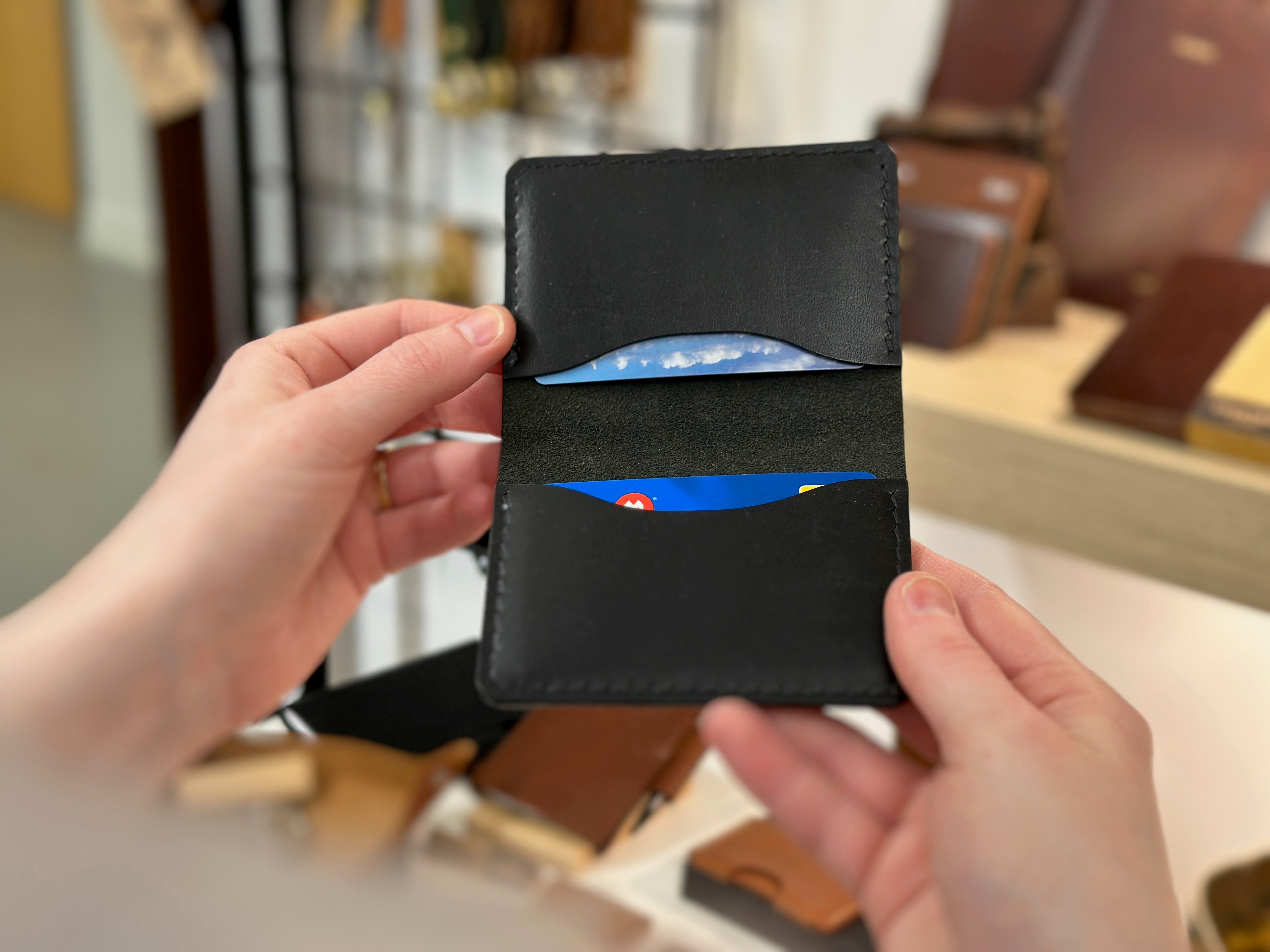 Open black belfry leather wallet held open to show two card pockets inside