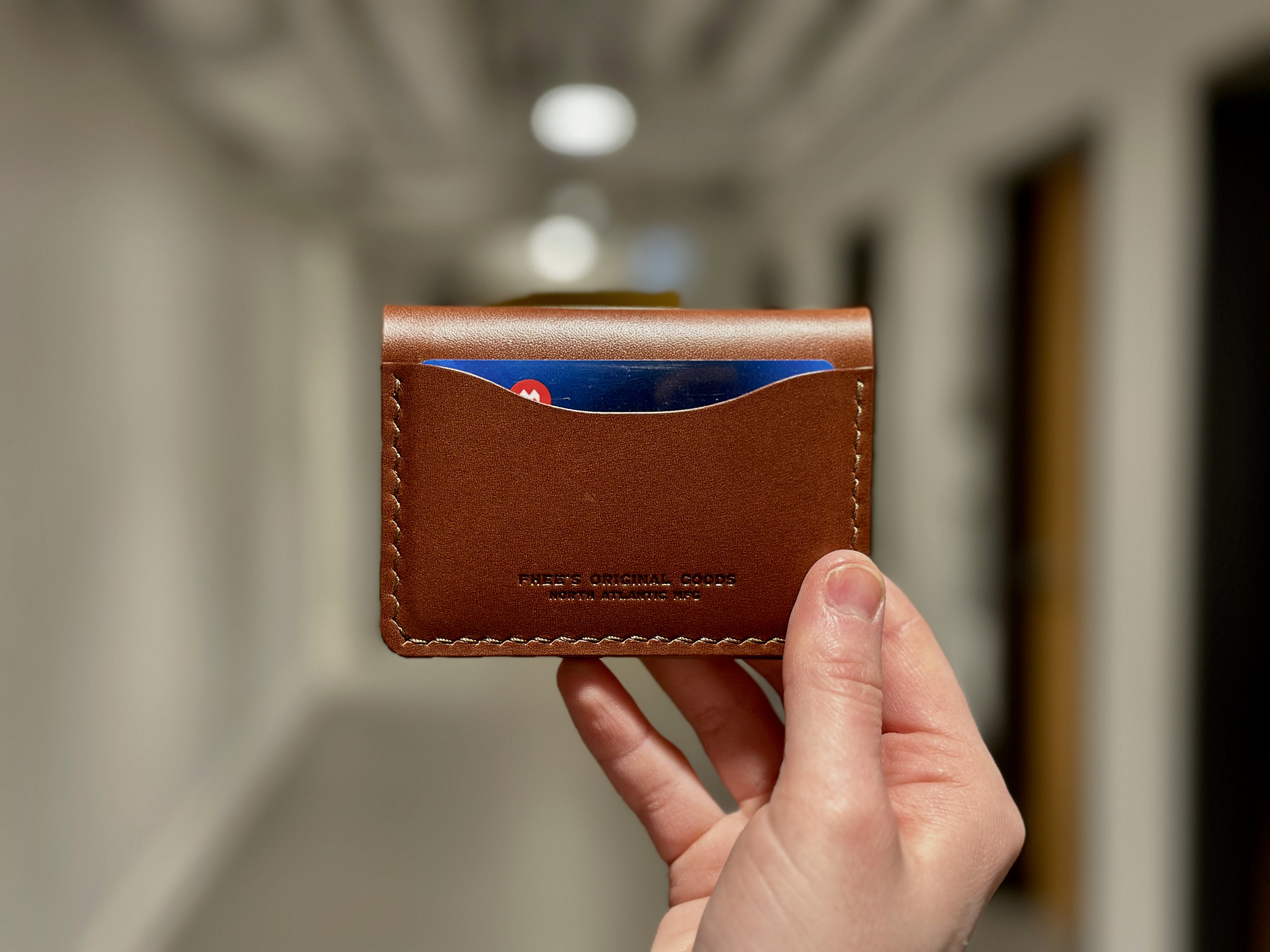 belfry leather bifold wallet held in hand