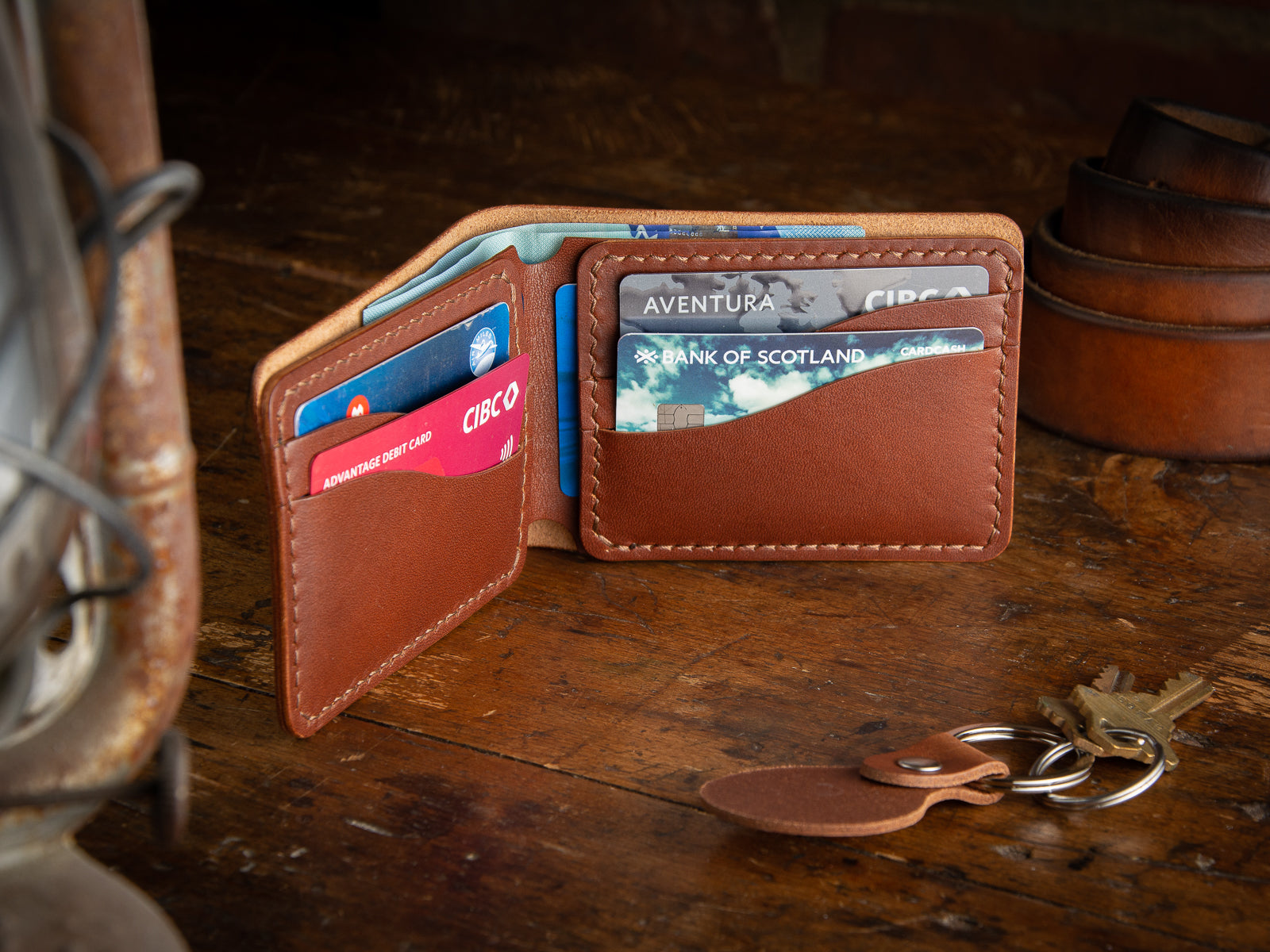 Bucklaw bifold wallet in brown - laying on rustic table 