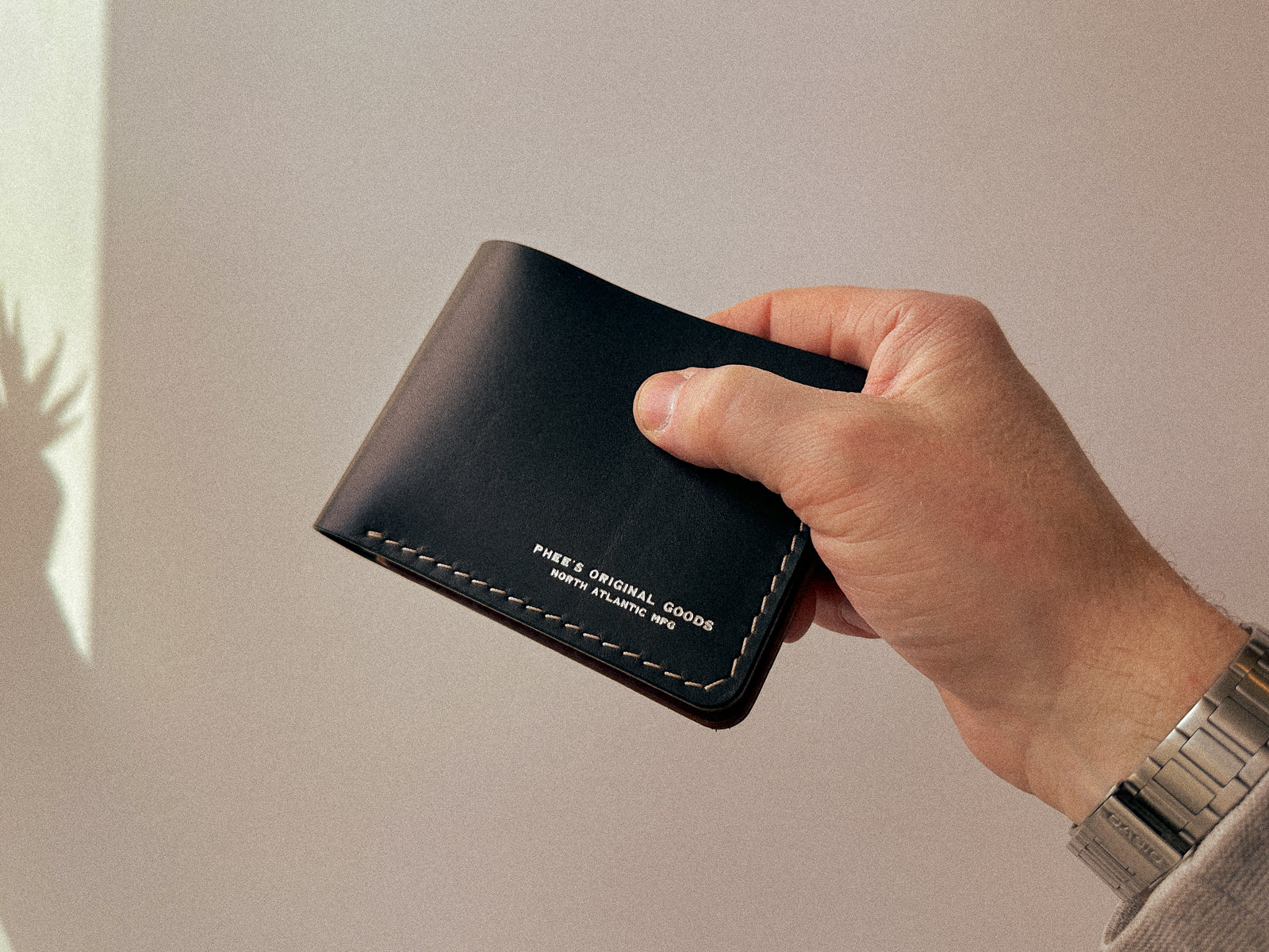 black leather build your own bucklaw wallet with taupe handstitching and silver monogram embossing