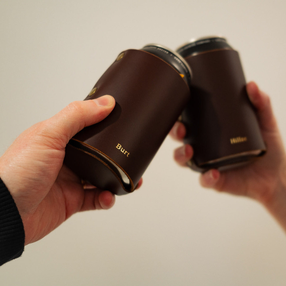 Brown leather can coozies embossed with gold foil nicknames
