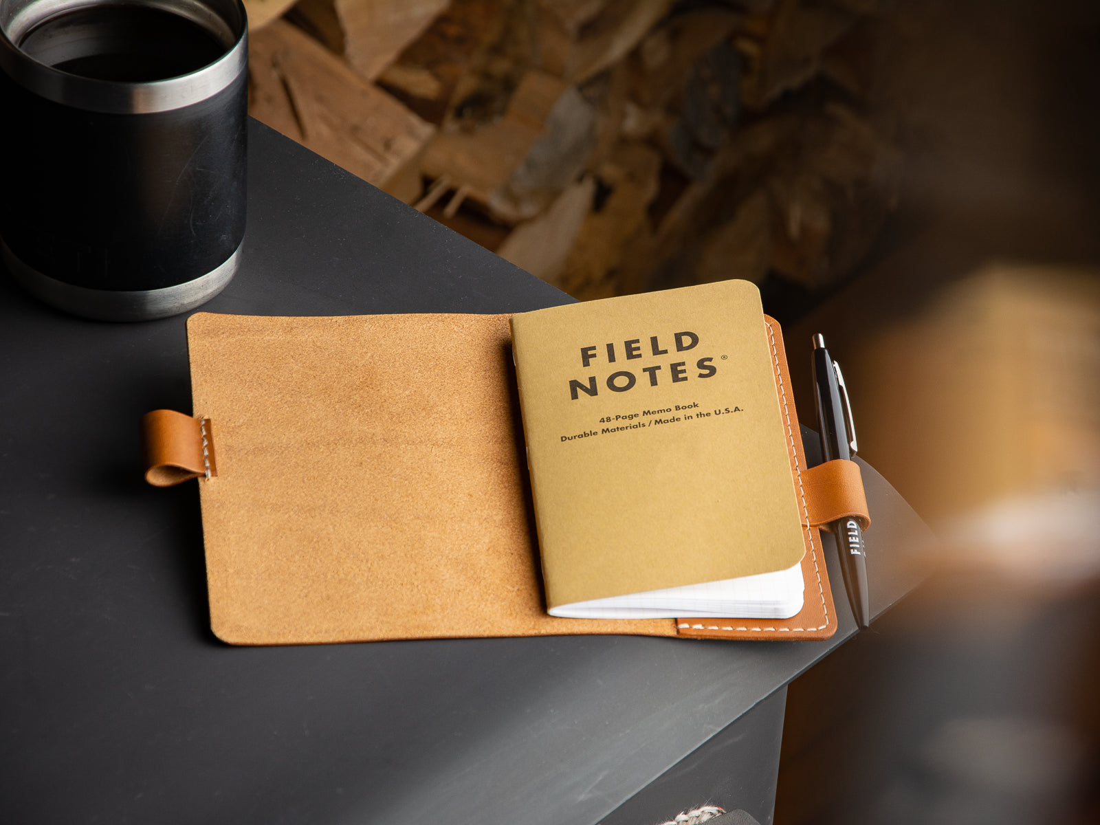 Field notes notebook and pan on a leather sleeve