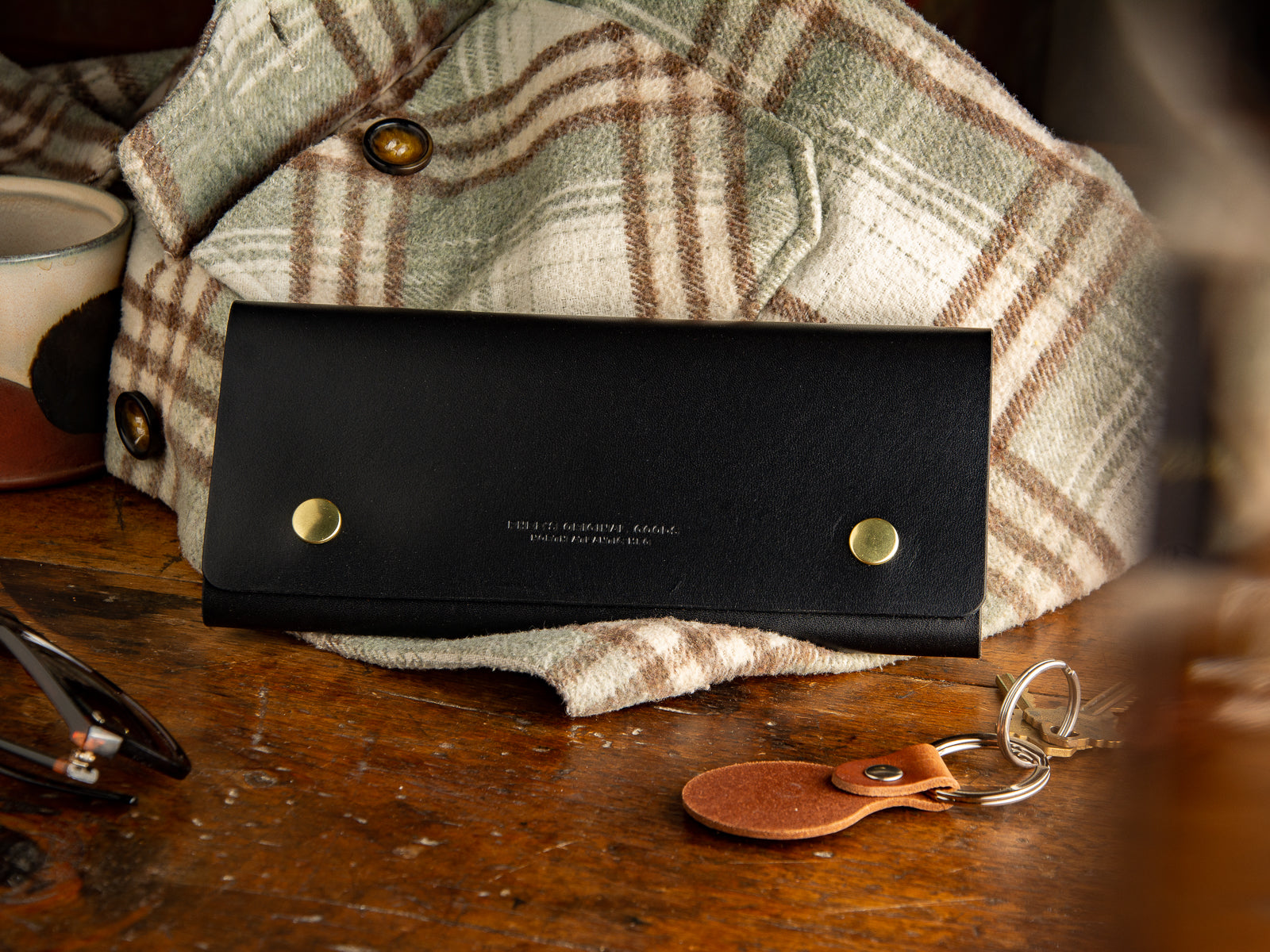 Glendale clutch wallet with optional wrist strap in black full grain leather