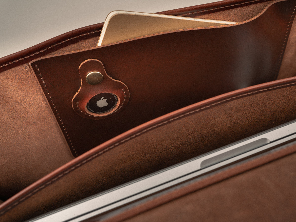 Interior photo of Glengarry Messenger bag showing Apple Air Tag pocket, notebook sleeve, and 14" computer sleeve