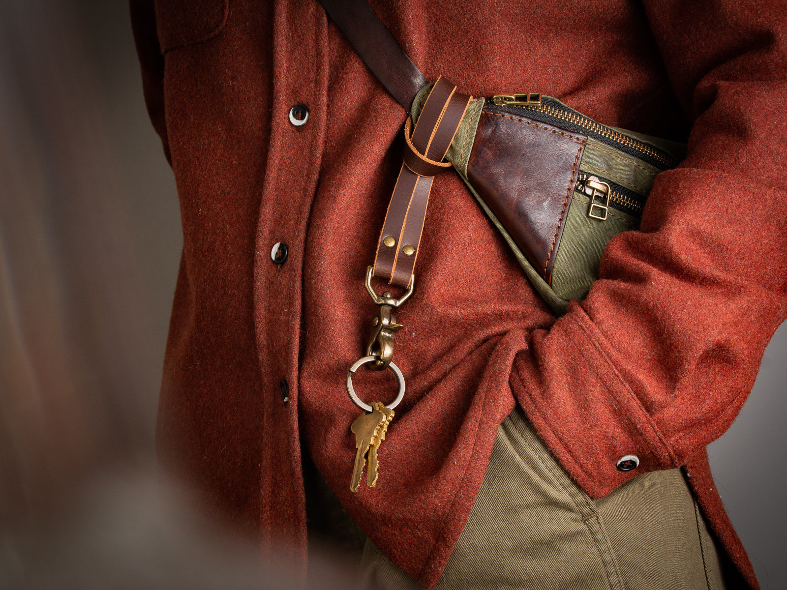 Key LAnyard in brown looped around a fanny pack bag strap