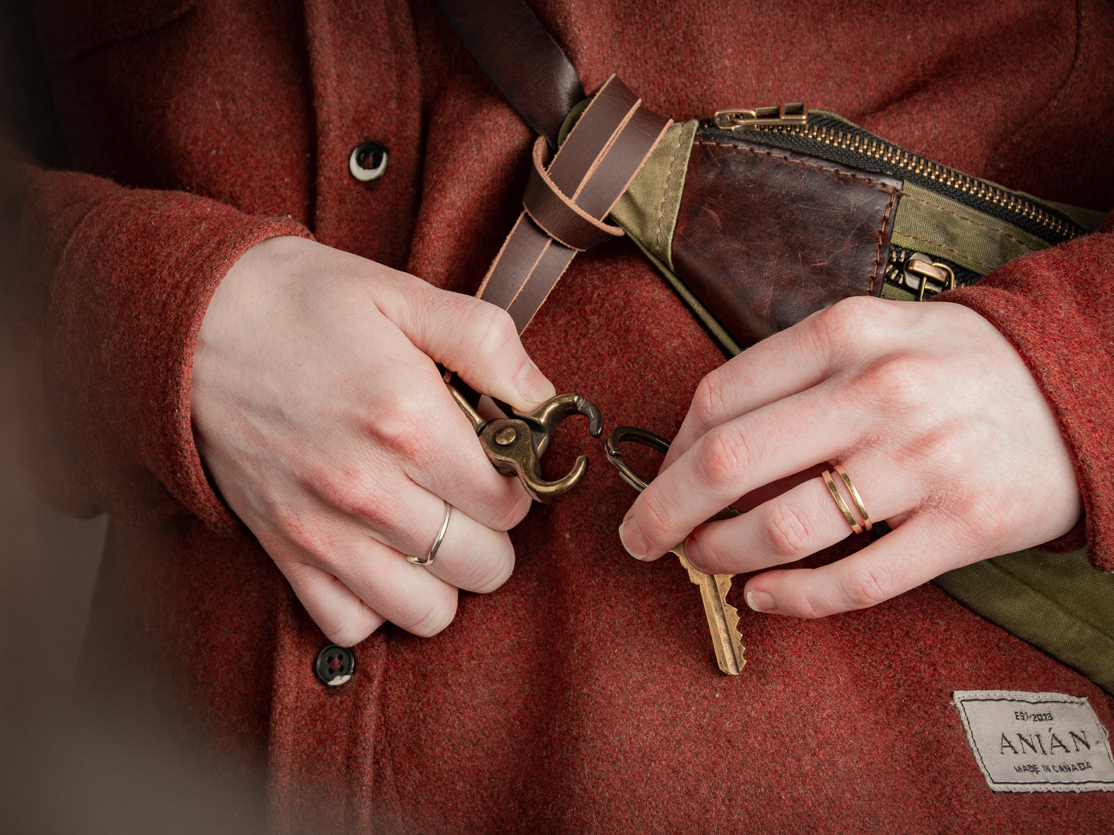 Key lanyard in brown in use looped on a bag with brass hardware