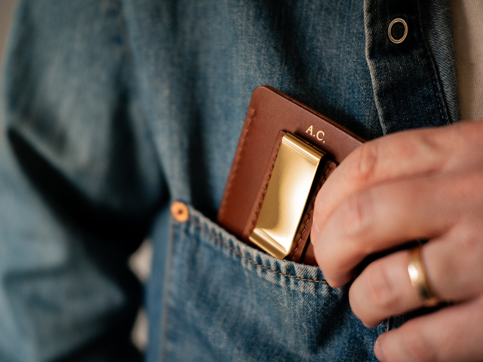Personalization embossed monogram on brown lewis wallet in gold finish