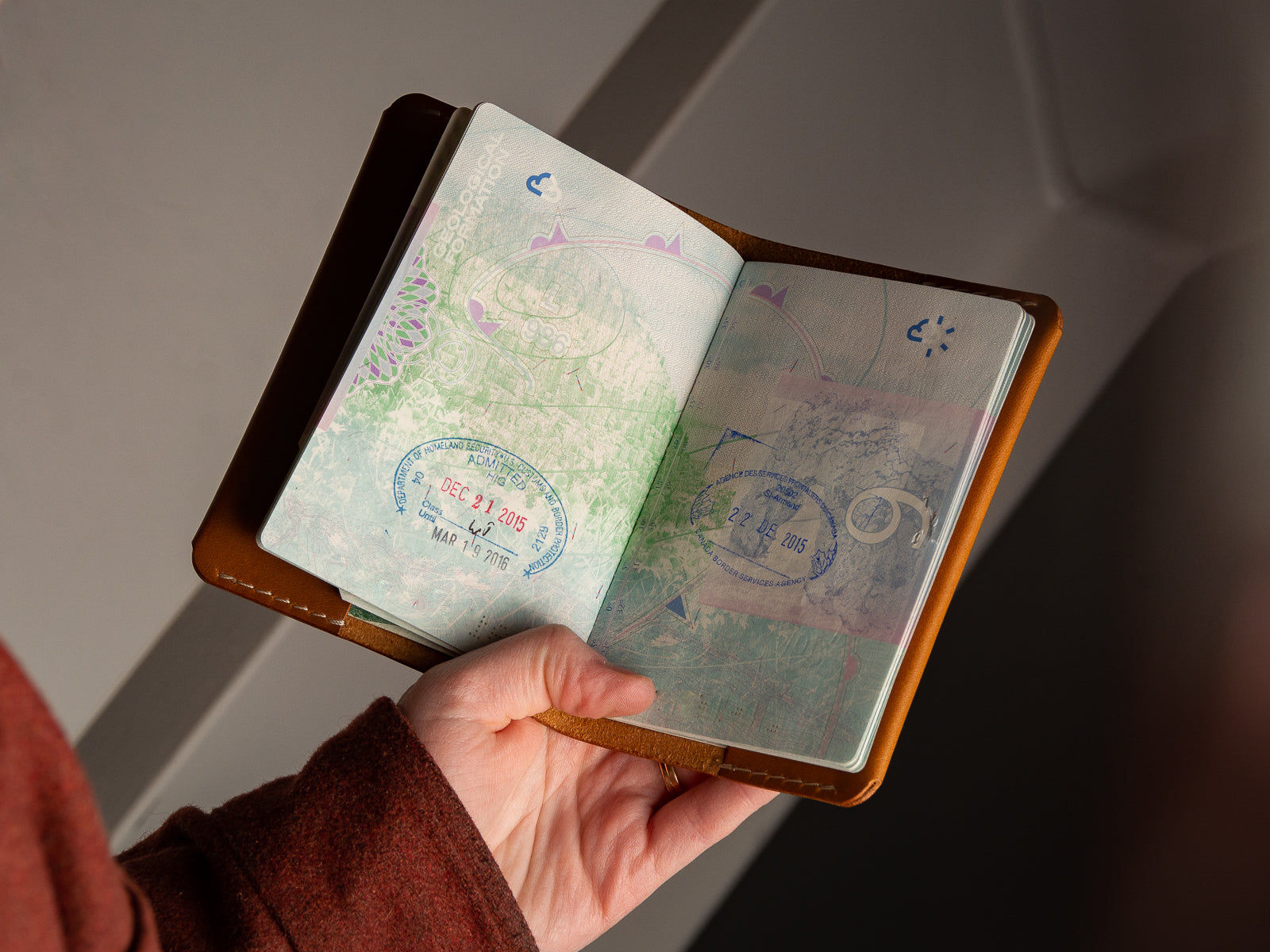 Open view of tan leather passport sleeve wallet