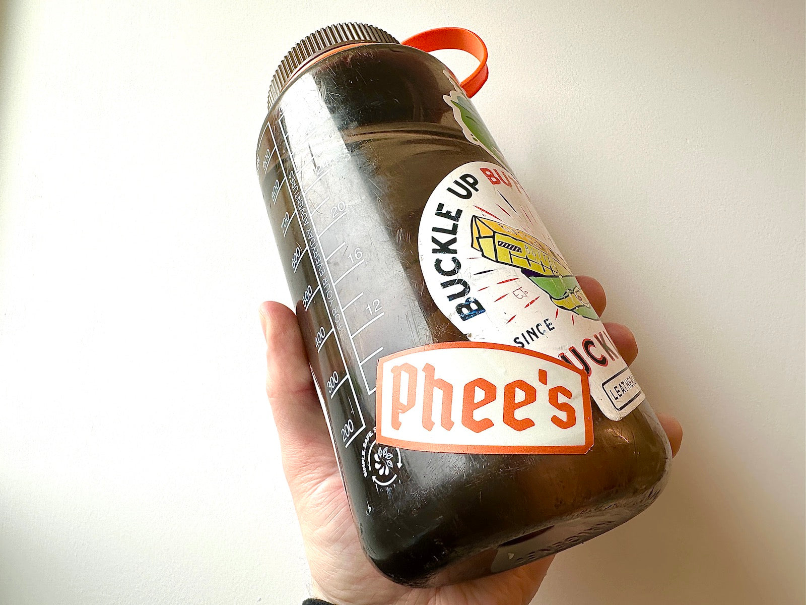Phee's Badge Sticker in Orange on a Naglene waterbottle