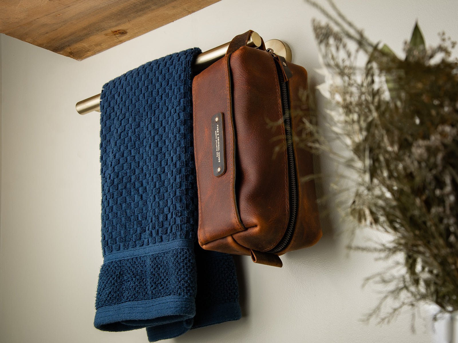leather toiletry bag, handmade with oiltan leather hanging in a bathroom