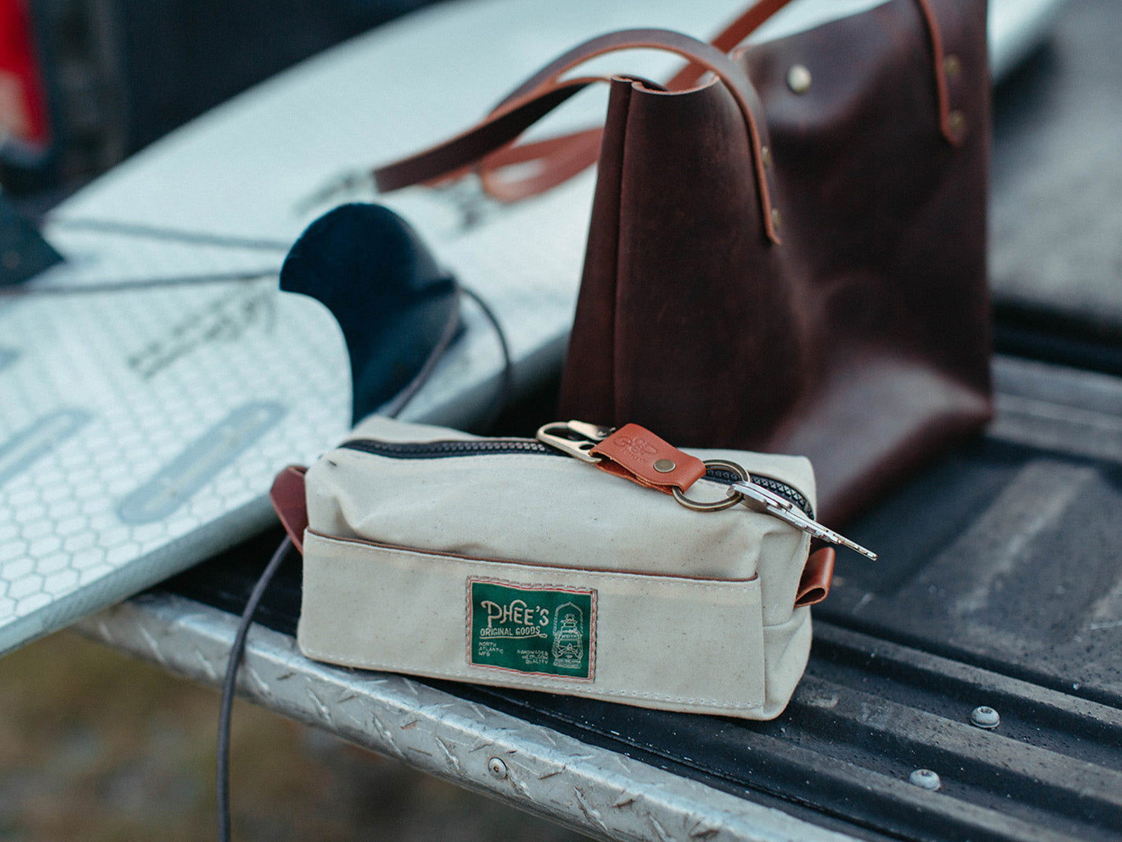 Canvas washabuck shaving kit in natural cream waxed canvas sitting on the bed of a truck