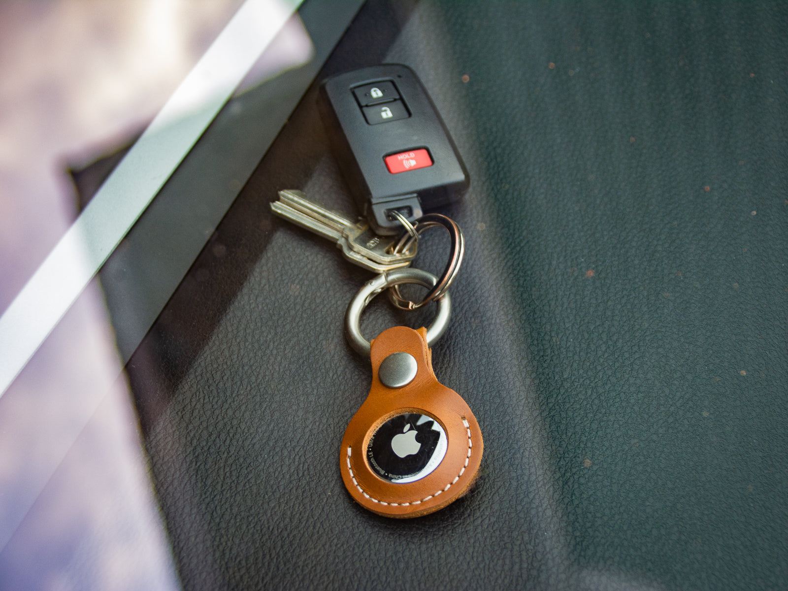 Handmade leather air tab fob keyring with keys on dashboard