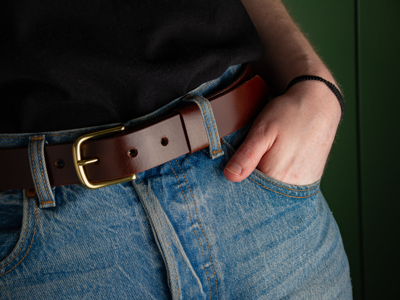 Close up of dark brown leather ashfield belt with brass hardware