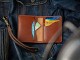 Barra simple bi-fold leather wallet in brown, showing cards and cash