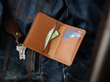 Barra slim bifold wallet in tan veg-tan leather open showing cash and cards