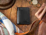 Closed view of black veg-tan leather Bateston wallet with exterior card slot
