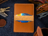 The belfry fold card wallet open showing the inner pockets amongst some EDC items