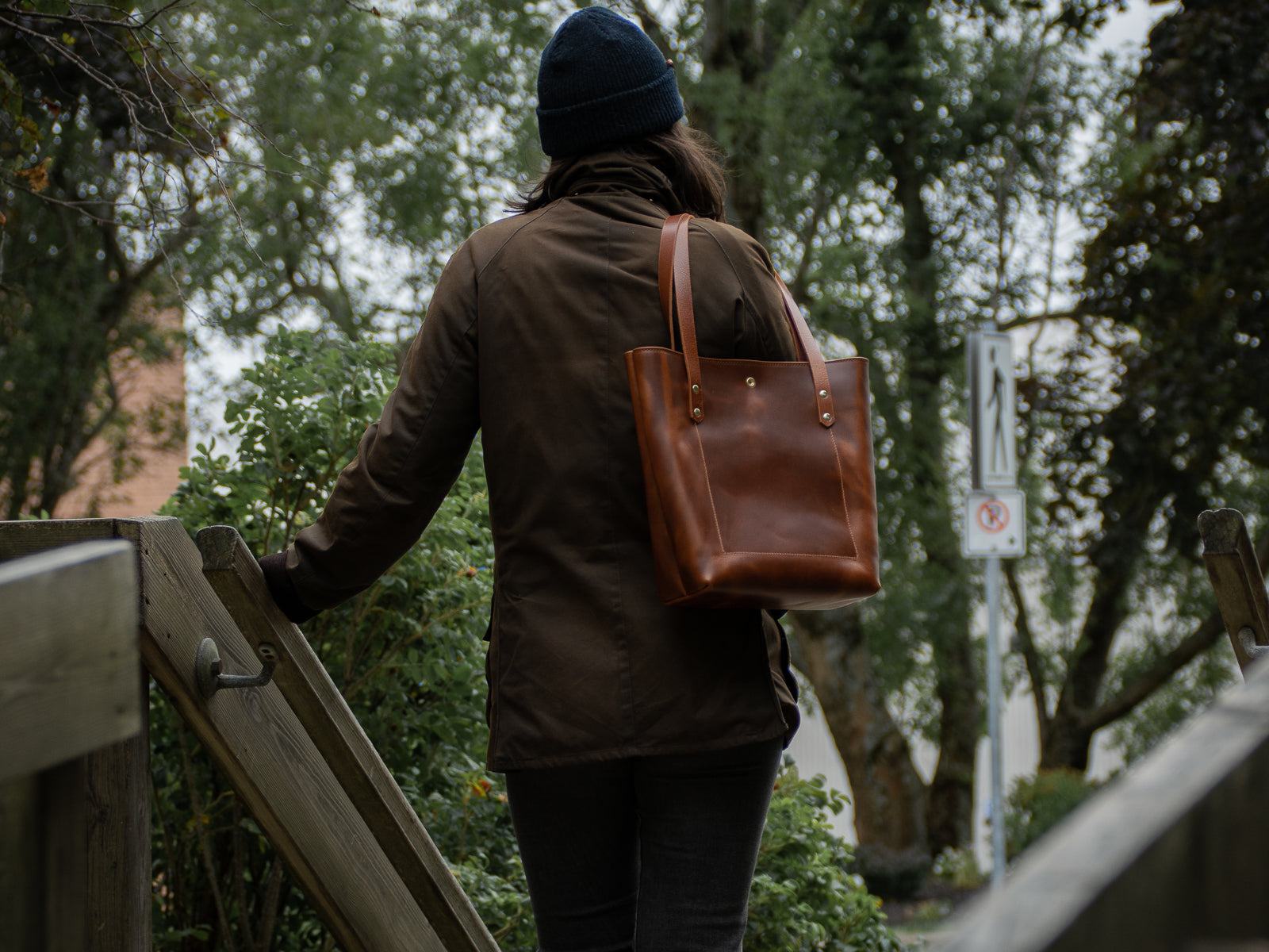 Big Bras d'Or Leather Tote Bag shown in tan from behind showing outline of large interior pocket.