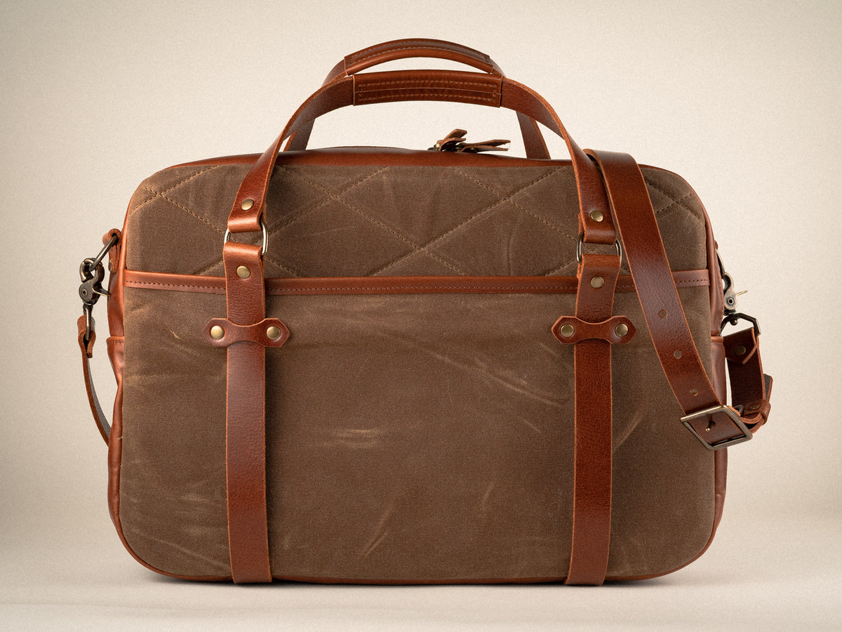 quilted side view of the campbellton messenger bag in nutmeg canvas with tan leather, showng cross body strap