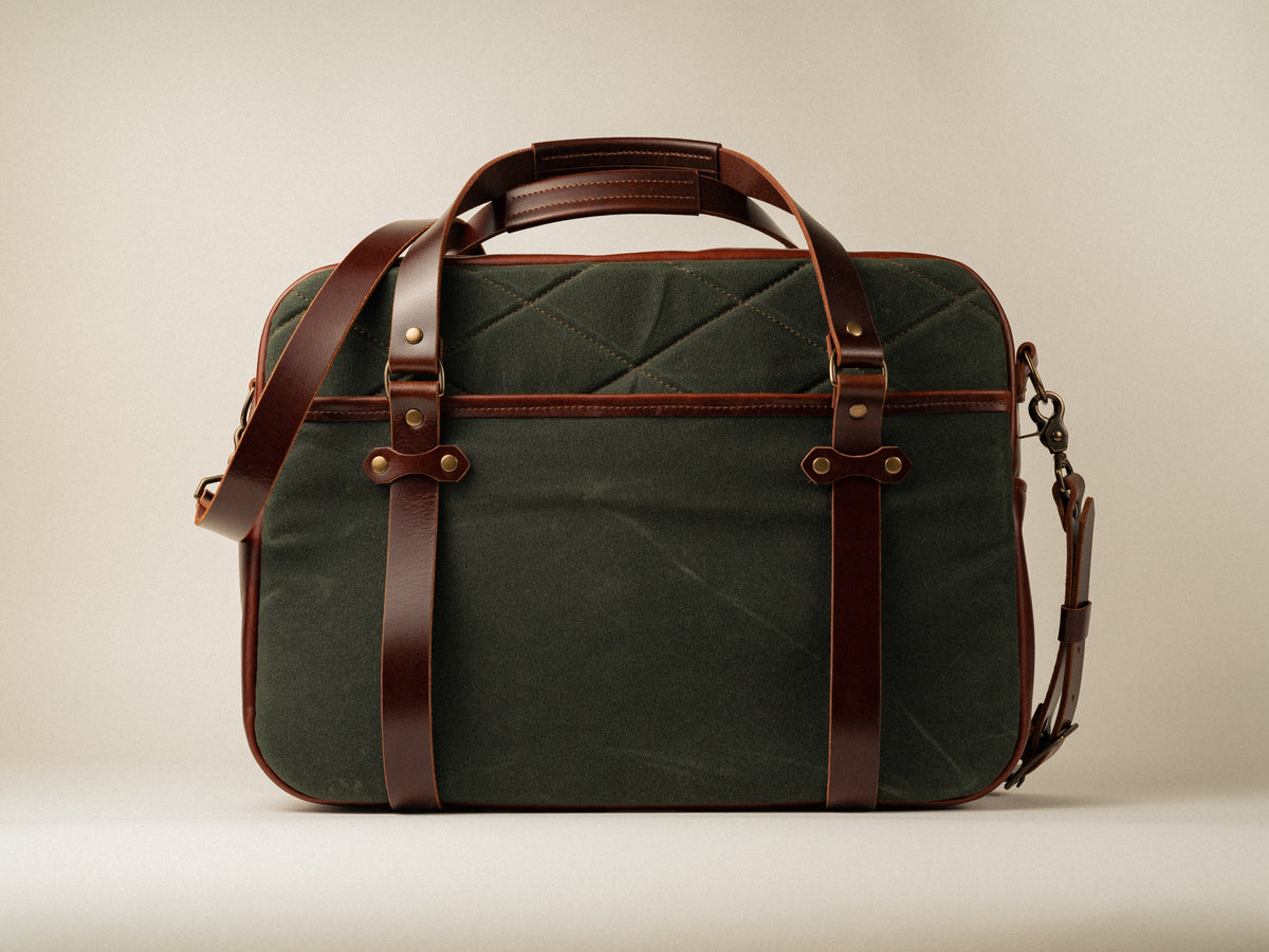 Quilted side view of campbellton messenger bag in olive canvas with brown accents.