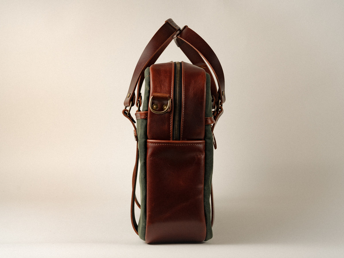 side view of campbellton messenger bag, showing brown leather gusset and antique brass hardware