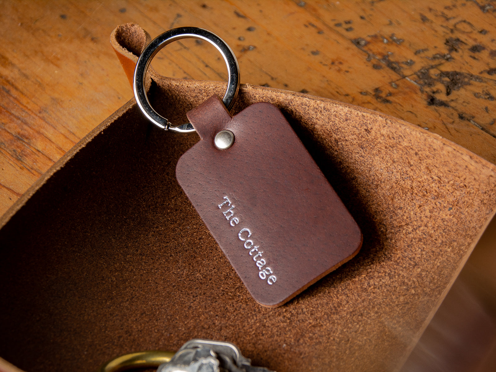 custom personalized leather keychain with "the cottage" embossed