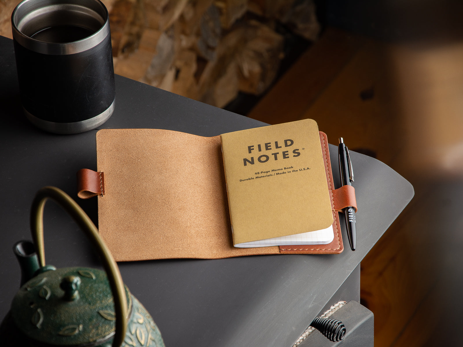 Brown leather notebook sleeve with fieldnotes notebook and pen