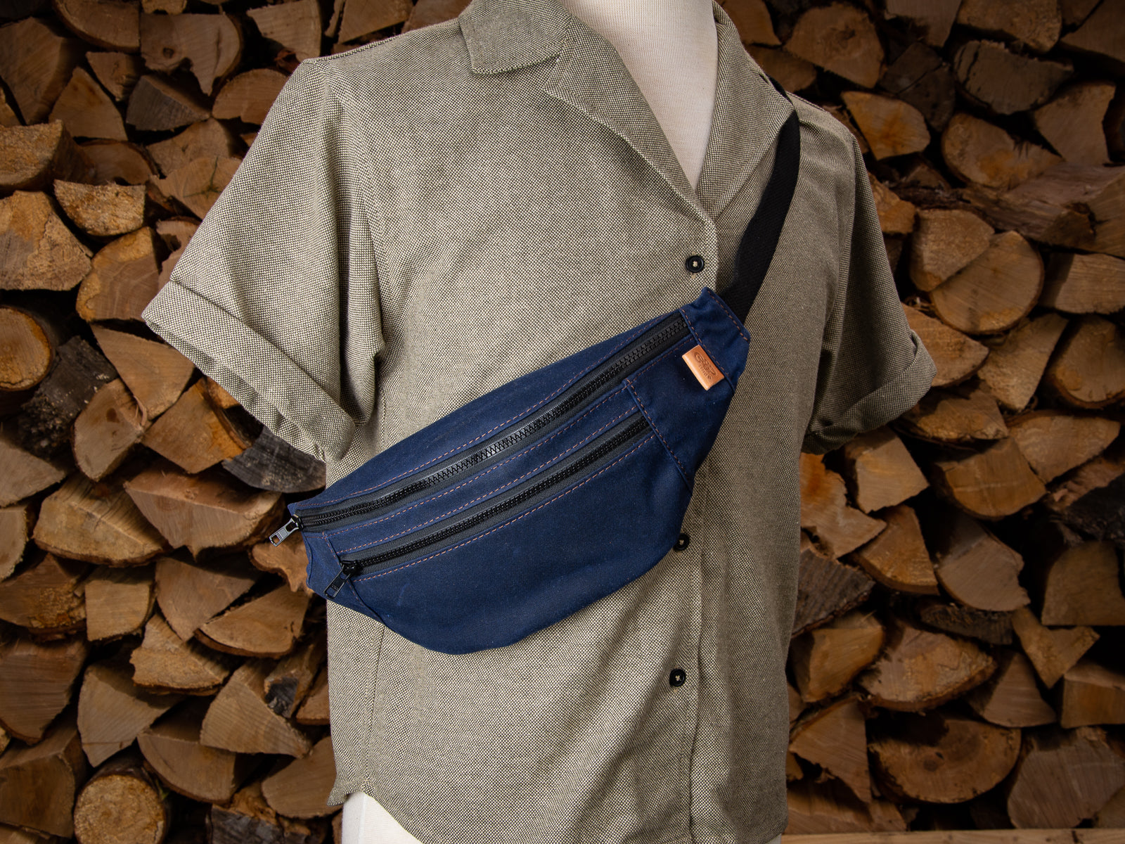 Navy waxed canvas Franey fanny pack on a mannequin
