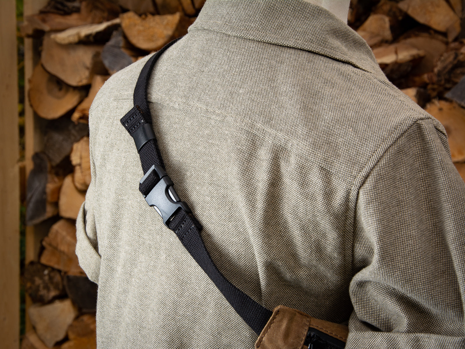 Detail picture of plastic clasp lock on strap of nutmeg colour waxed canvas fanny pack.