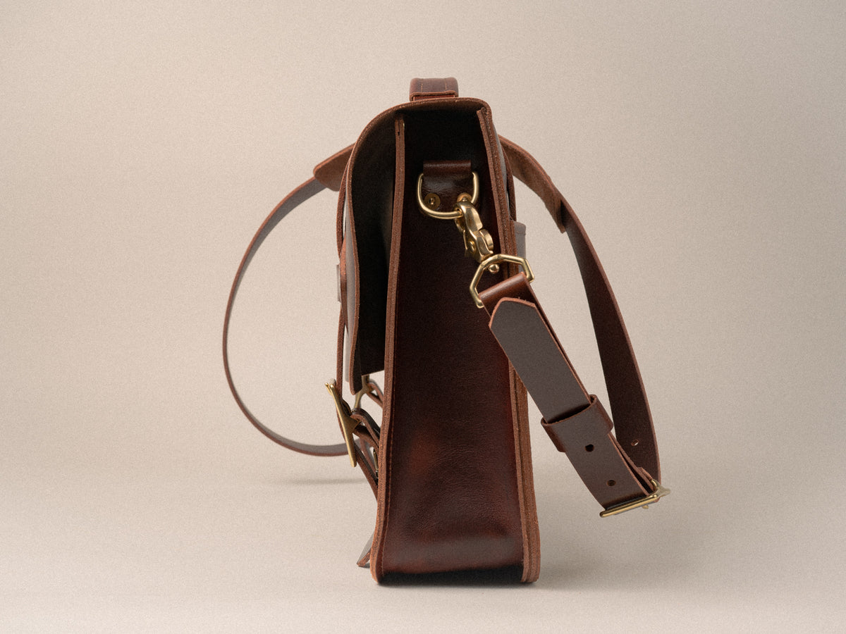 Side view of the glengarry messenger bag gusset showing removal shoulder strap with brass hardware.
