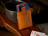 Kenloch pull tab minimalist card wallet sitting on an arm chair in tan full grain leather