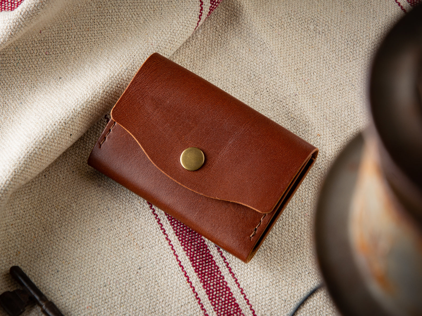 front of brown leather no. 11 pouch wallet with antique brass snap closure