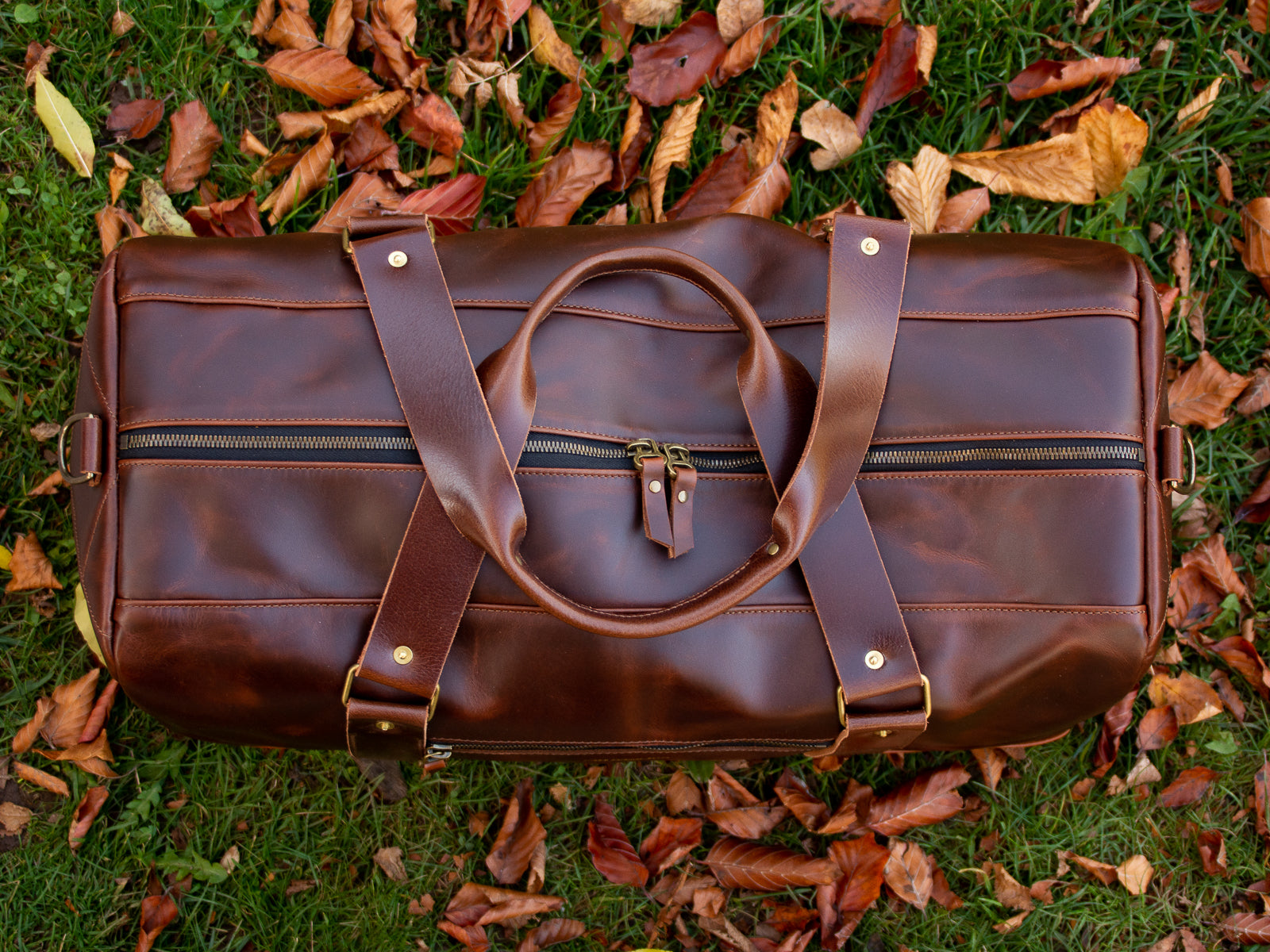 The Reserve Duffel Bag looking right at home in some fall leaves. Shown from directly above the double zipper.