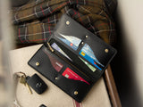 Rosedale full-grain leather wallet in black with brass hardware, sitting open on a front hallway table