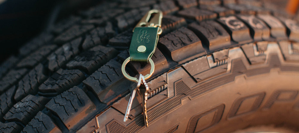 Stubby keychain in pine sitting on top of a truck tire