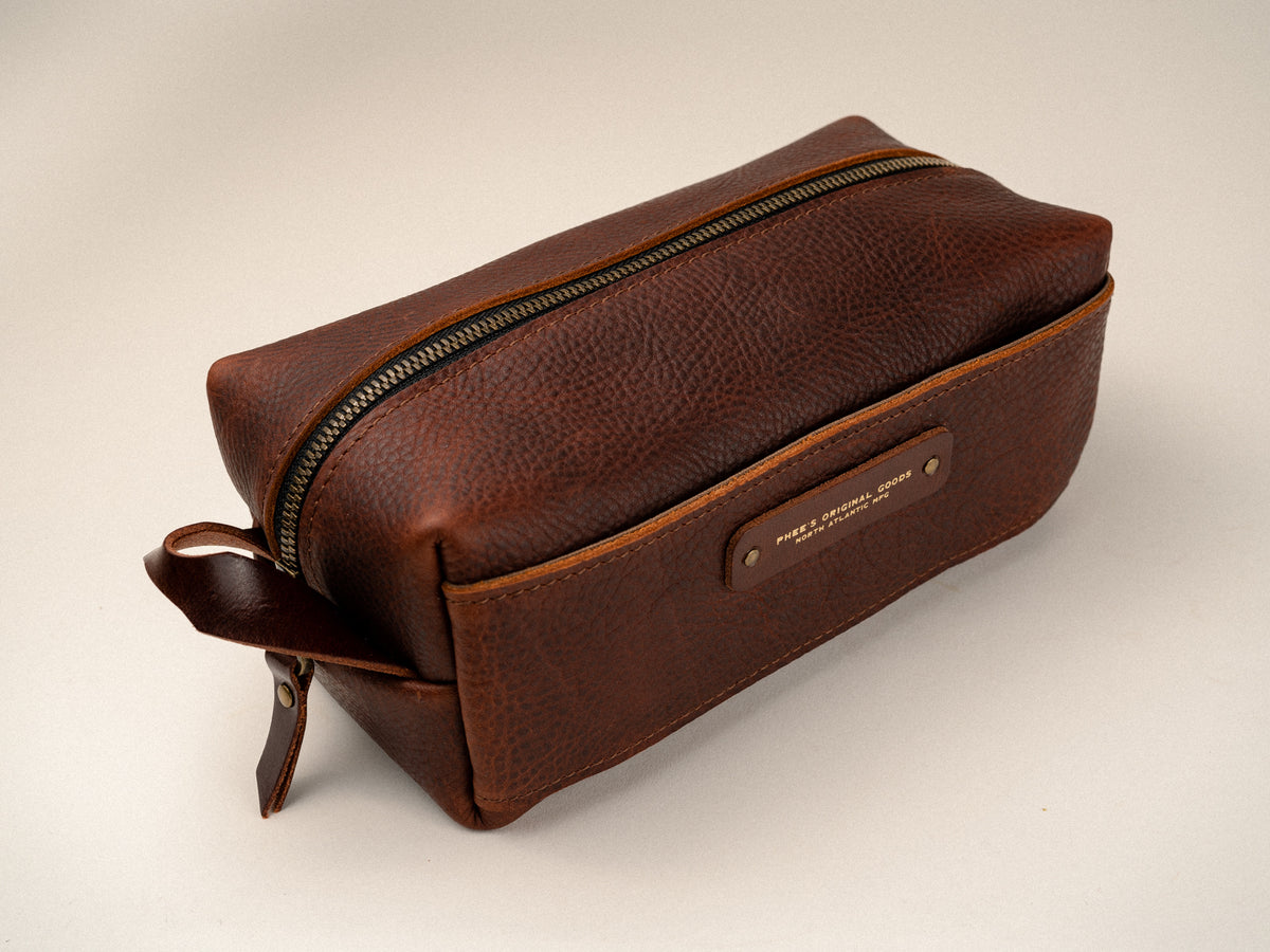 top view of brown leather washabuck shaving kit with antique brass zipper and side pocket