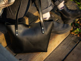 Front of black Big Bras d'Or tote bag in black oil tan leather