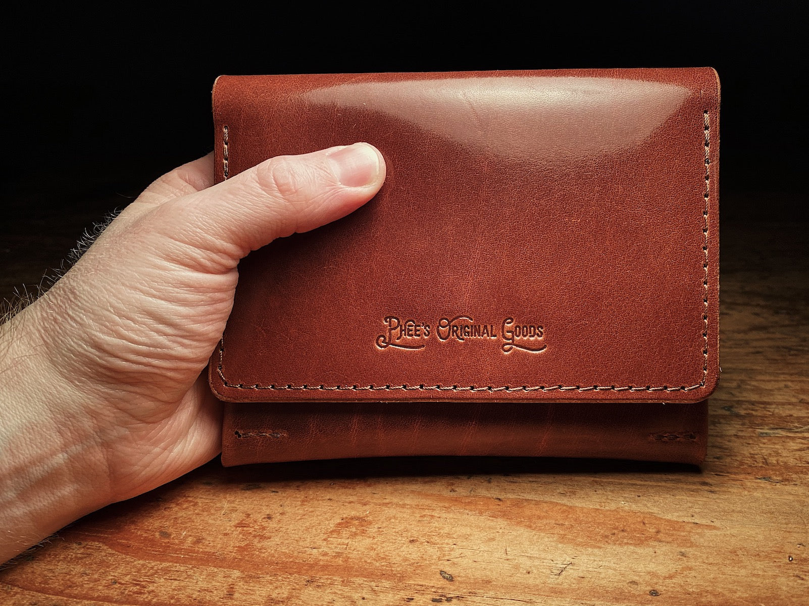 closed up fly fishing wallet in brown veg-tan leather