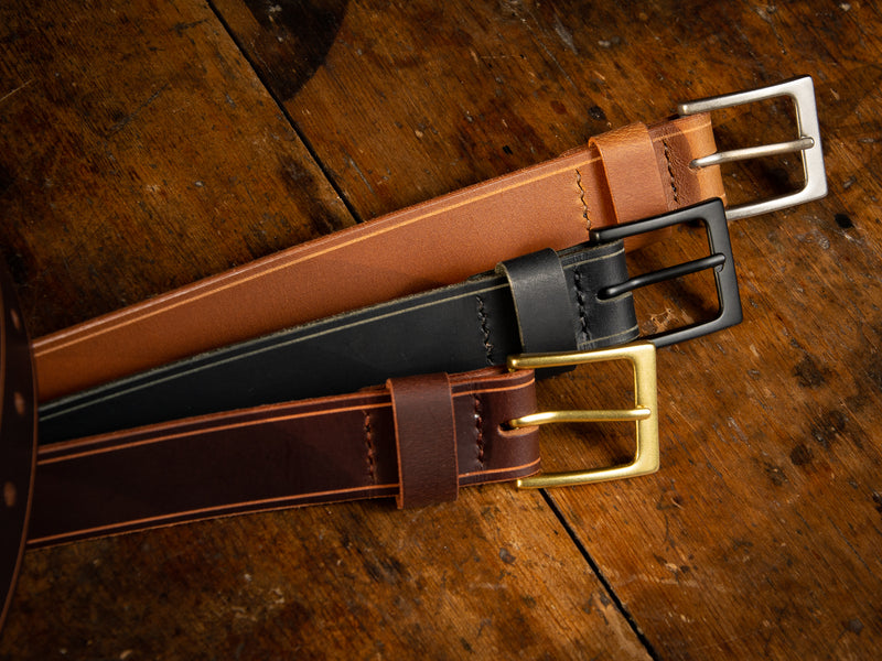 Our Sterling Dress Belt shown in all three colours, brown, black, and tan. Showing the hand stitching that keeps the buckle secured.