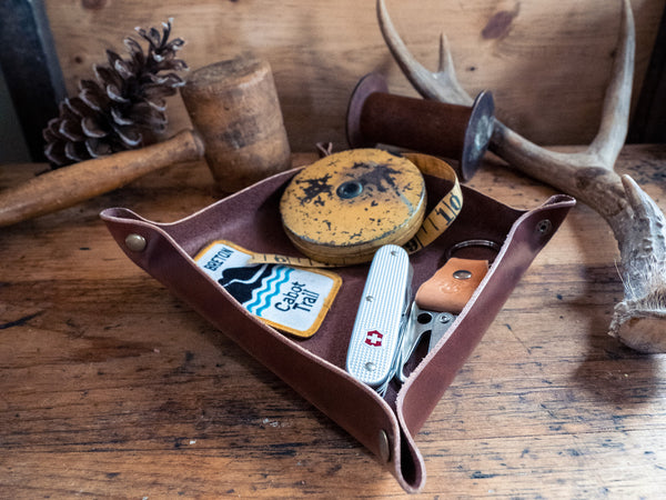 Leather valet tray with assortment of vintage objects